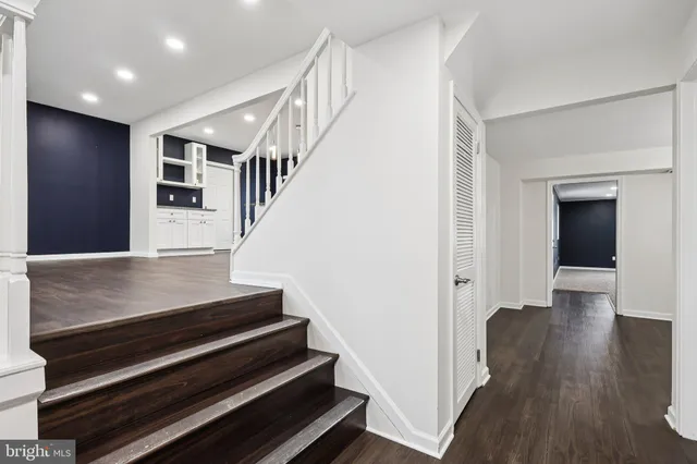 a view of entryway and hall with wooden floor