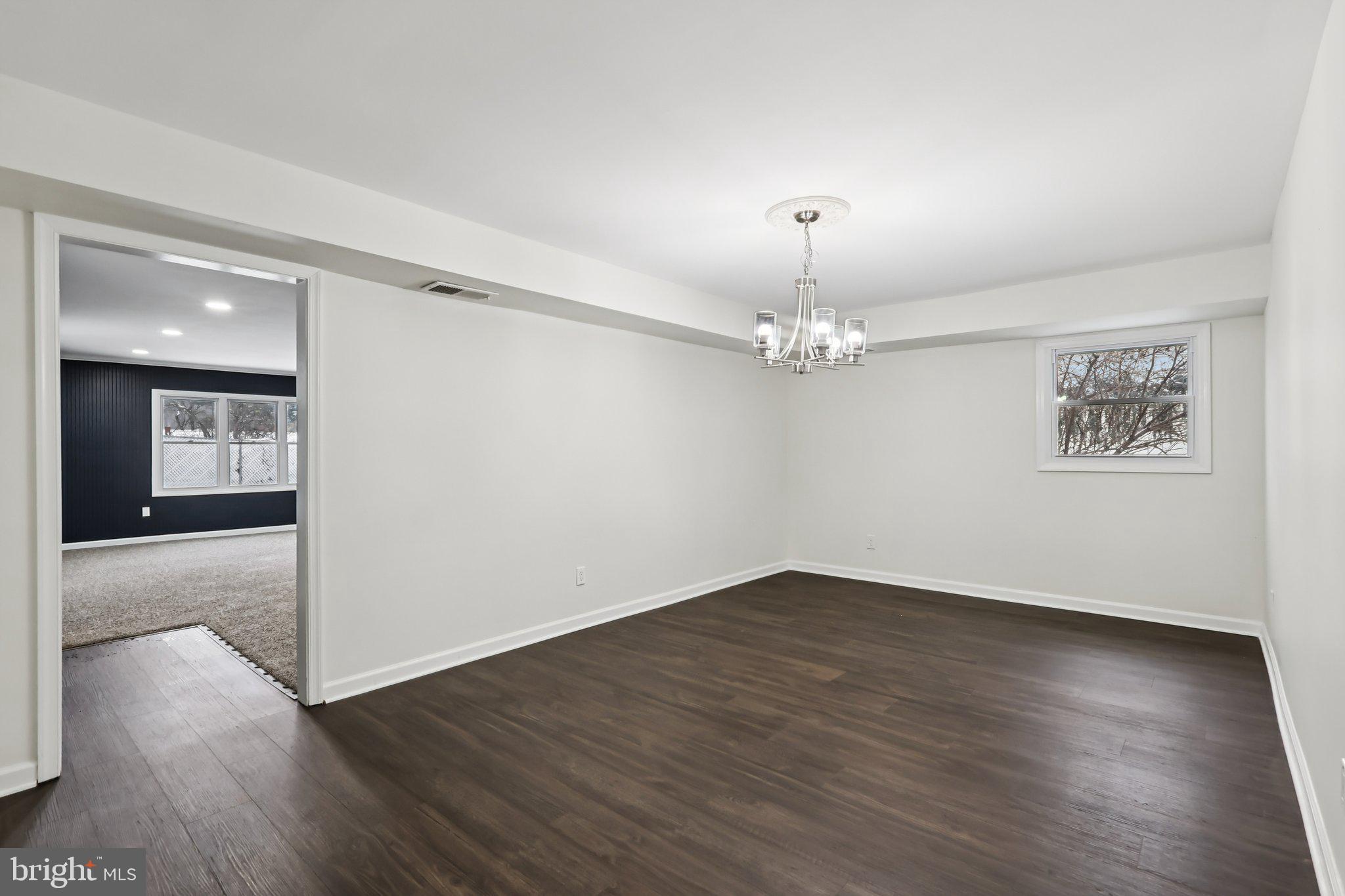 103 Anglin Drive Newark, DE 19713 - Photo 5 of 25 a view of an empty room with wooden floor and a ceiling fan