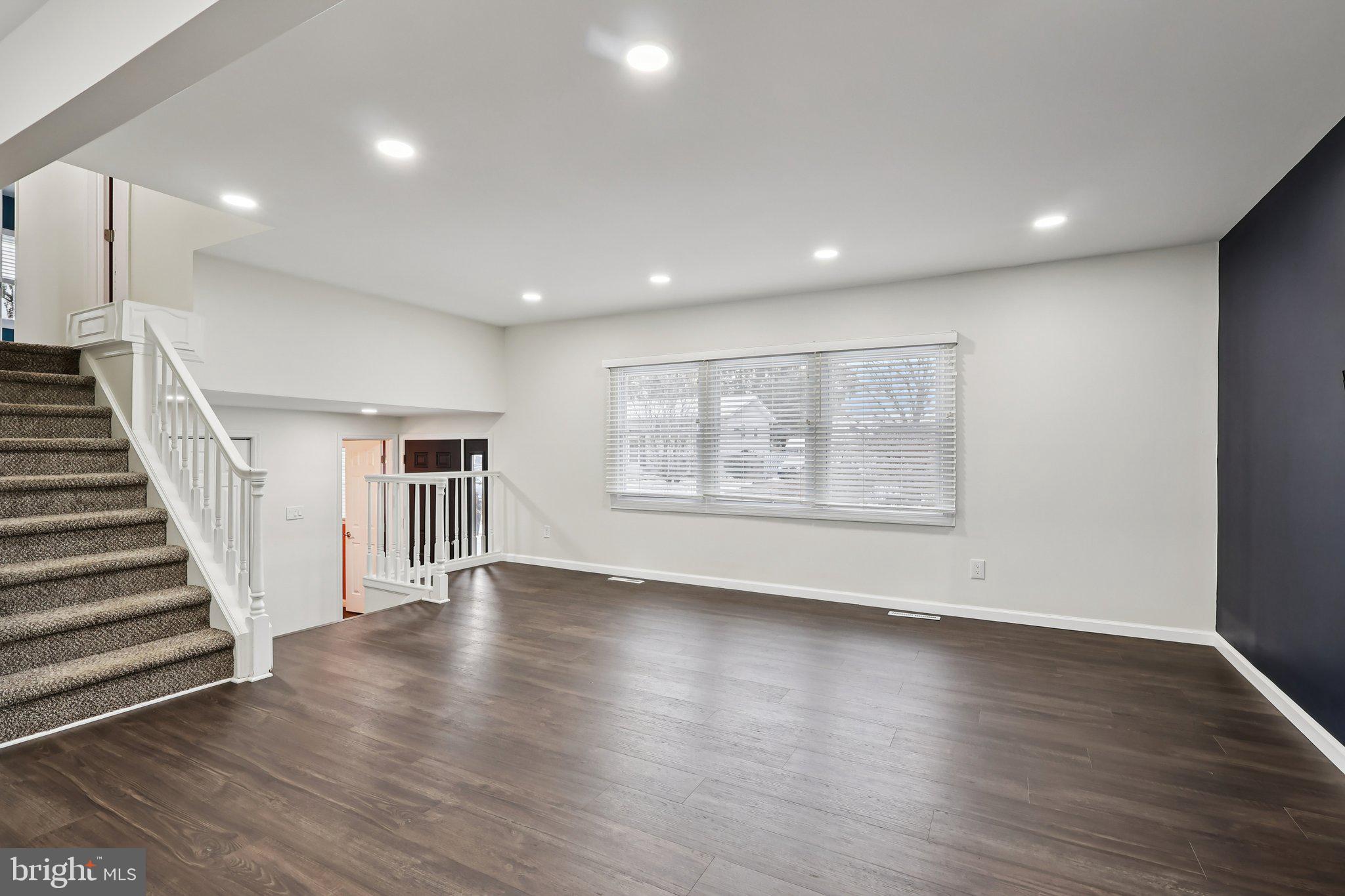 103 Anglin Drive Newark, DE 19713 - Photo 10 of 25 an empty room with wooden floor and windows