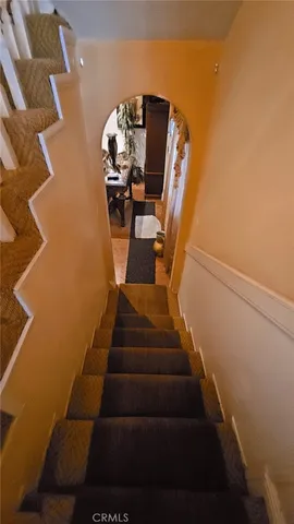 a bedroom with furniture and a chandelier
