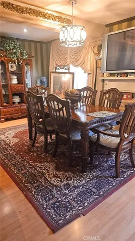 a dining room with a wooden table and chairs