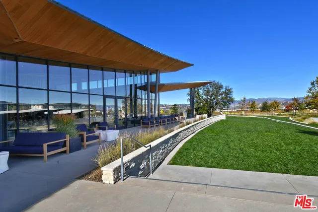 a view of a patio with dining table and chairs