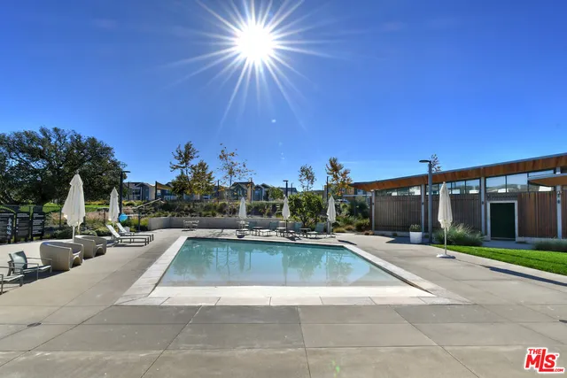 a kitchen with a table chairs stove and sink