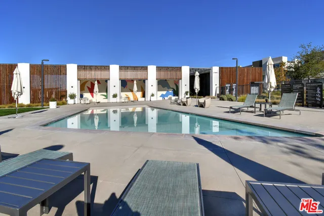 a swimming pool with outdoor seating