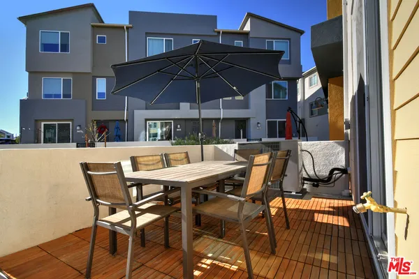 a view of a hallway with wooden floor and entryway