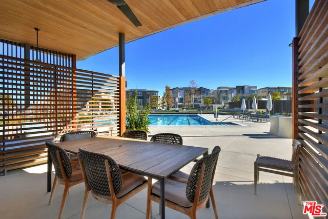 a view of a house with swimming pool and sitting area