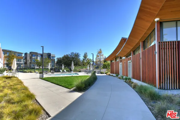 a view of residential houses with outdoor space and swimming pool