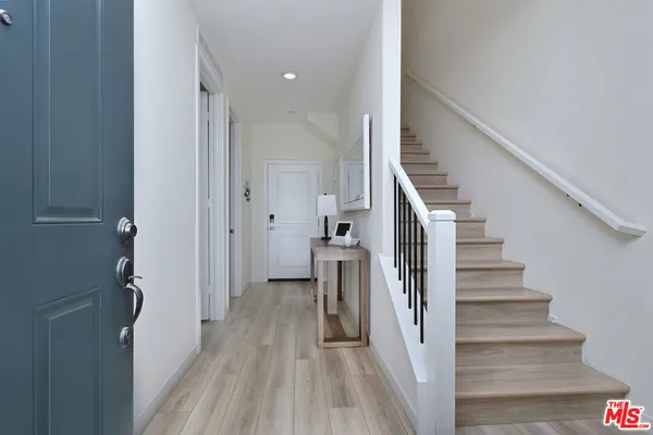a view of hallway with wooden floor