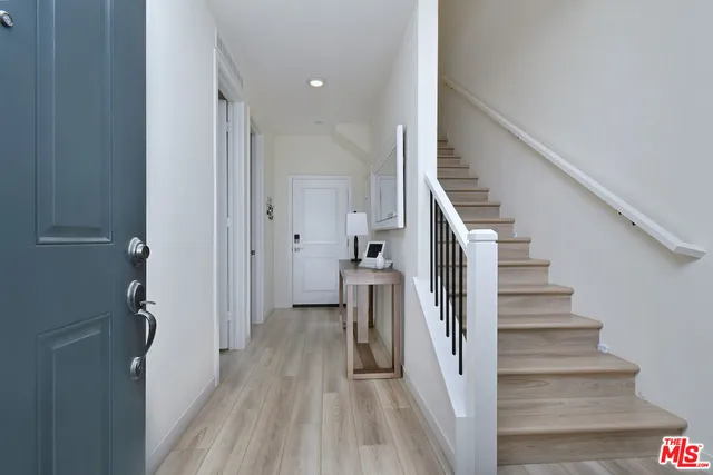 a view of hallway with wooden floor