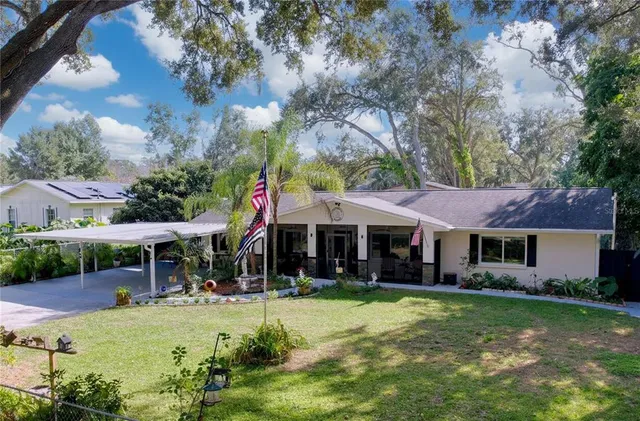a view of a house with a yard porch and sitting area