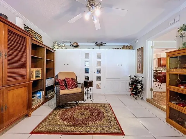 a living room with furniture a rug and a bookshelf