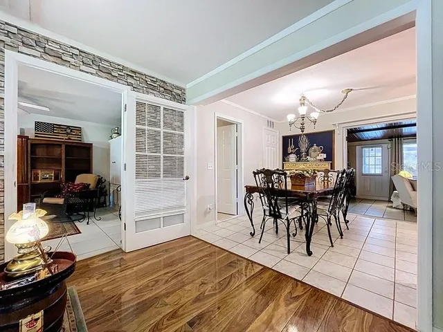 a view of a dining room with furniture and chandelier
