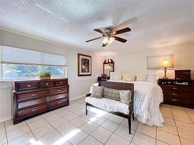 a room with pool table windows and flat screen tv