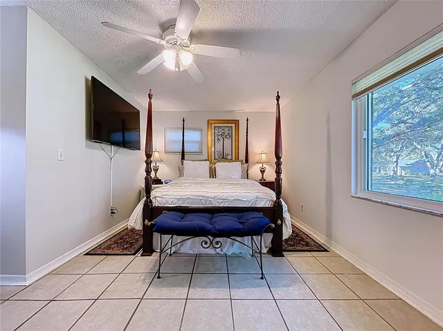 a bed room with a bed and a chandelier