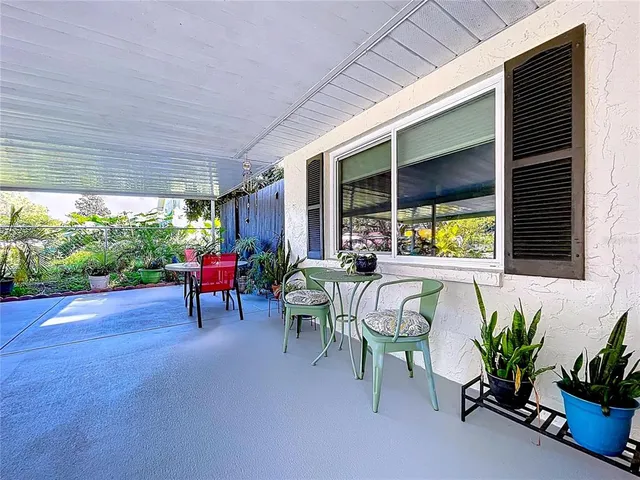 a living room filled with furniture and a potted plant