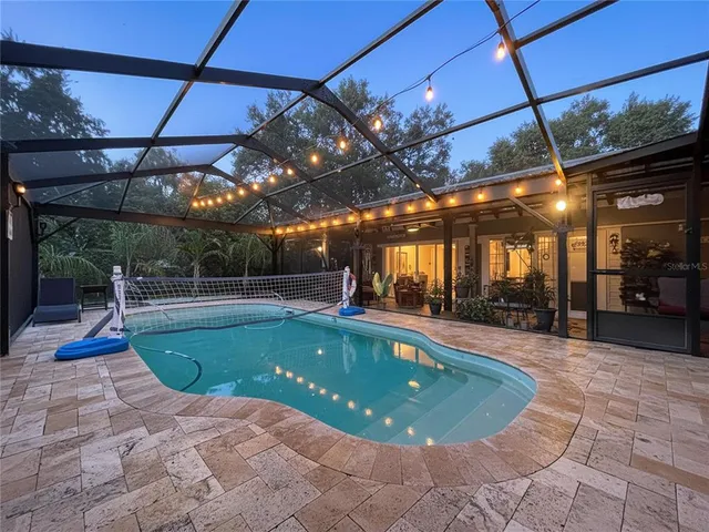 an aerial view of a house with a swimming pool