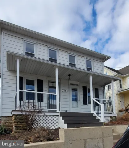a front view of a house with a porch