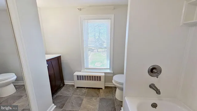 a bathroom with a sink a toilet and a tub