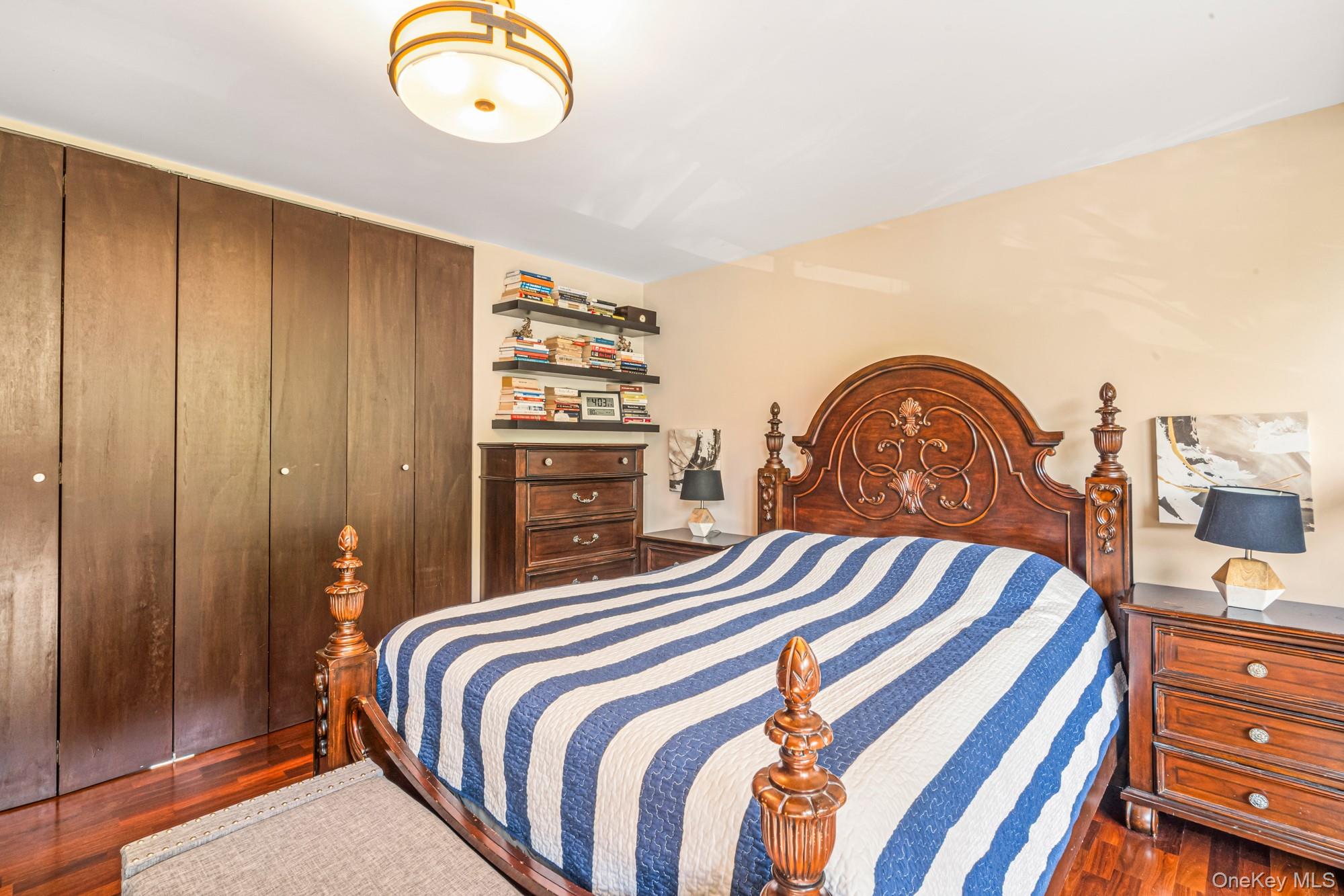 168-01 12th Avenue, Unit 3A Queens, NY 11357 - Photo 14 of 22 a bedroom with a bed and a dresser