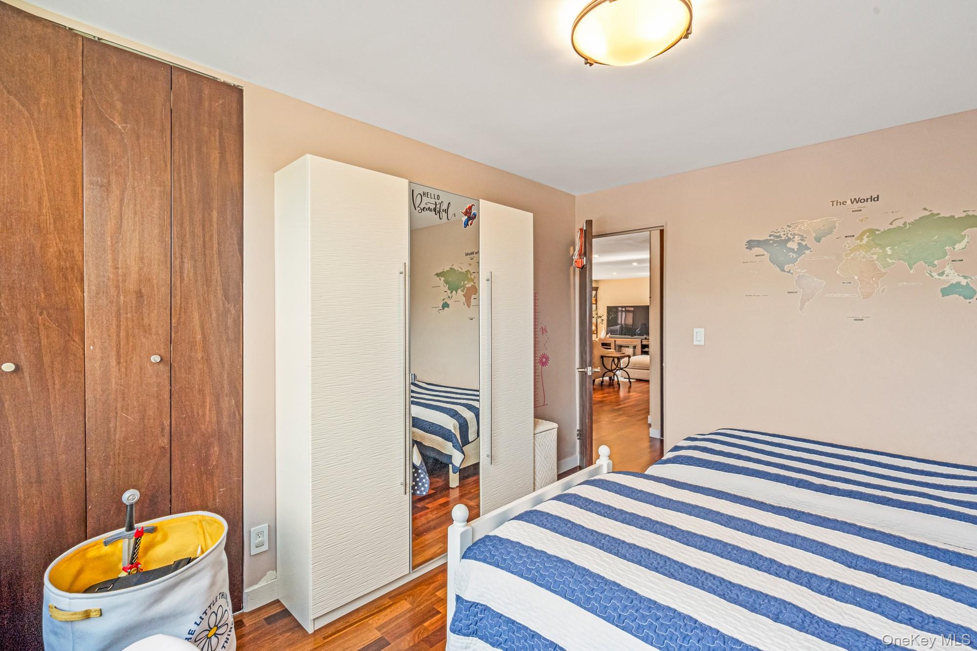 168-01 12th Avenue, Unit 3A Queens, NY 11357 - Photo 17 of 22 a view of a bedroom with furniture and wooden floor