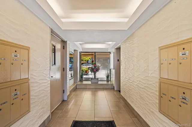 a hallway with white doors wooden floor and stair