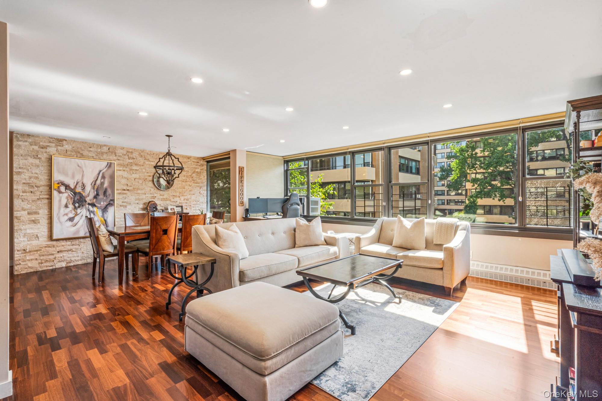 168-01 12th Avenue, Unit 3A Queens, NY 11357 - Photo 5 of 22 a living room with furniture and a large window