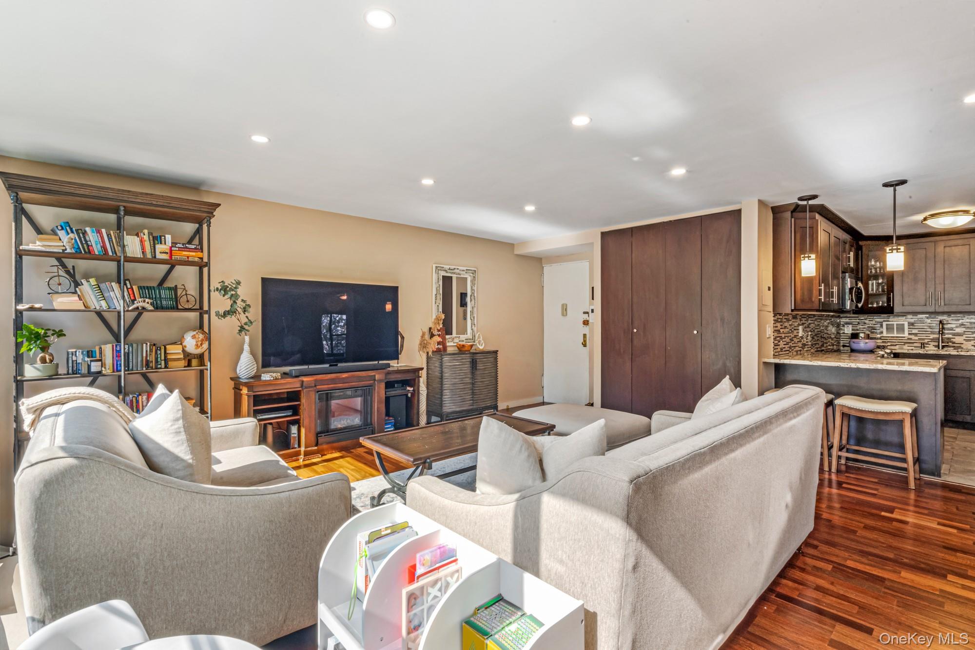 168-01 12th Avenue, Unit 3A Queens, NY 11357 - Photo 7 of 22 a living room with furniture and a flat screen tv