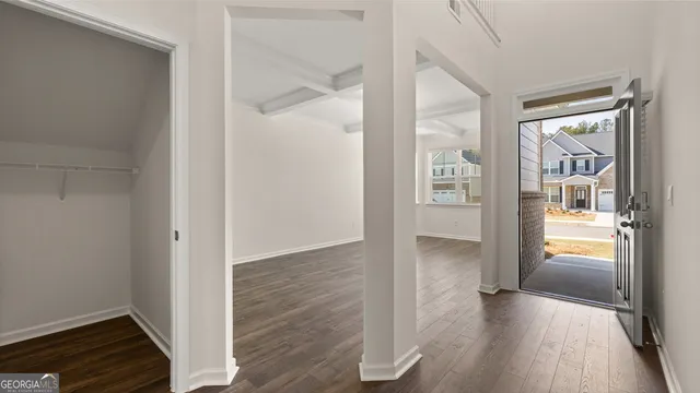 a view of hallway with wooden floor