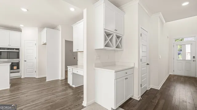 a large white kitchen with white cabinets