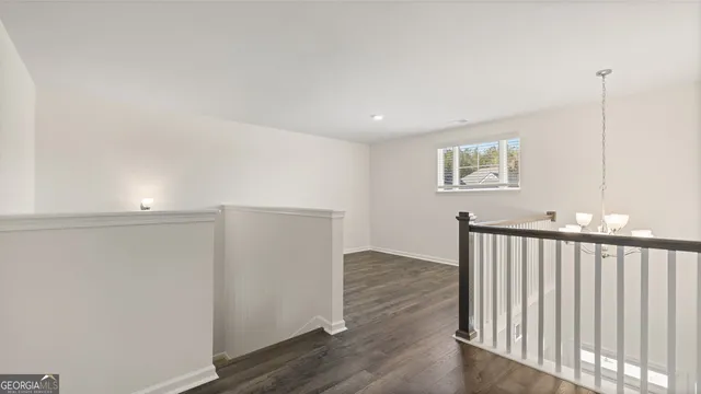 a view of hallway with wooden floor