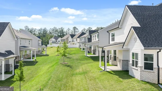 a view of house with a big yard and potted plants