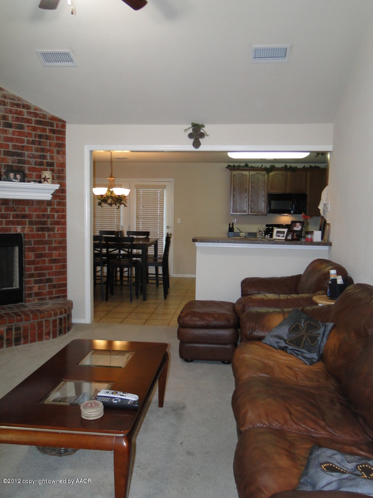 4805 Nimbus Lane Amarillo, TX 79110 - Photo 2 of 15 a living room with furniture a flat screen tv and kitchen view