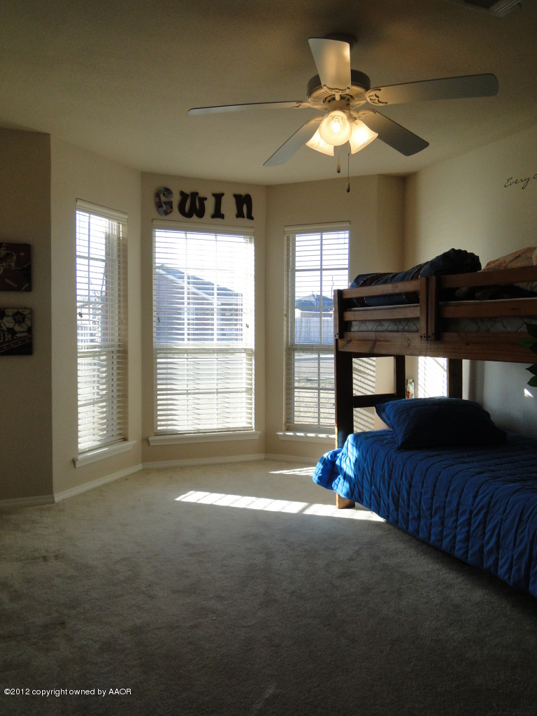 4805 Nimbus Lane Amarillo, TX 79110 - Photo 11 of 15 a living room with a bed furniture and a chandelier