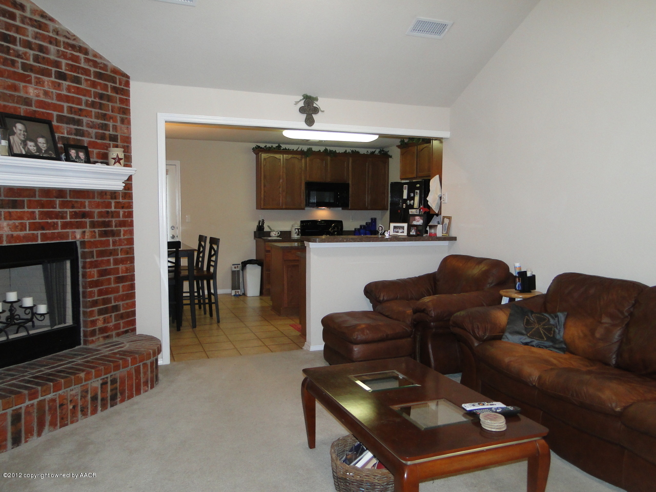 4805 Nimbus Lane Amarillo, TX 79110 - Photo 3 of 15 a living room with furniture a fireplace and a flat screen tv