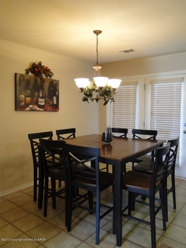 4805 Nimbus Lane Amarillo, TX 79110 - Photo 5 of 15 a view of a dining room with furniture and chandelier