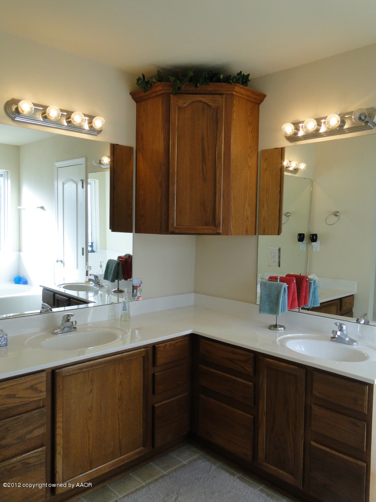 4805 Nimbus Lane Amarillo, TX 79110 - Photo 8 of 15 a bathroom with a sink and a mirror