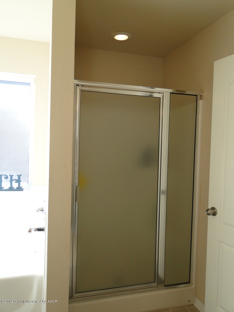 4805 Nimbus Lane Amarillo, TX 79110 - Photo 10 of 15 a bathroom with a glass shower door