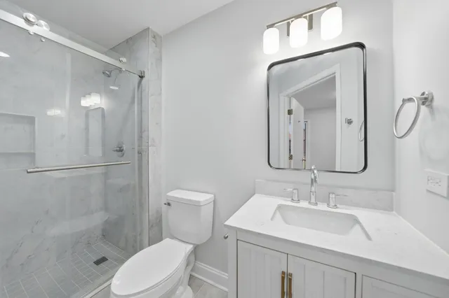 a bathroom with a sink toilet and shower