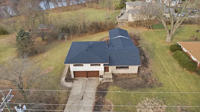 an aerial view of a house with a yard