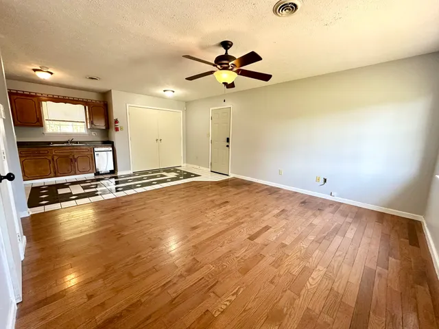 a view of a room with wooden floor