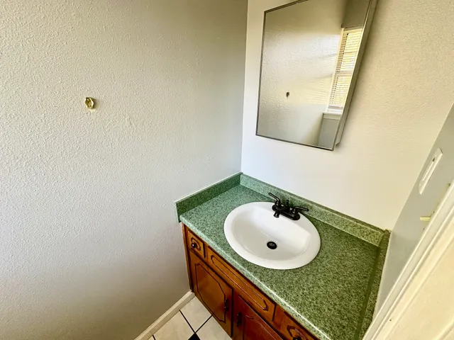 a bathroom with a sink and mirror