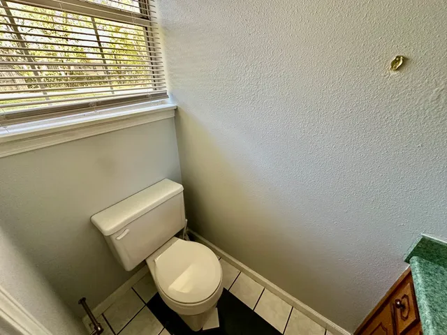 a white toilet sitting next to a window