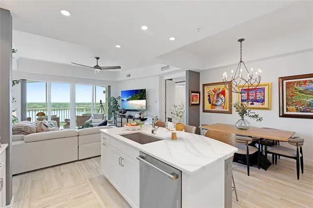a kitchen that has a lot of cabinets a sink and a refrigerator