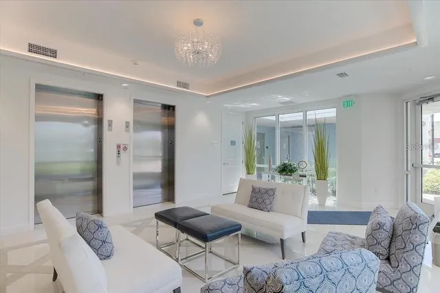 a dining hall with stainless steel appliances granite countertop a sink and a refrigerator