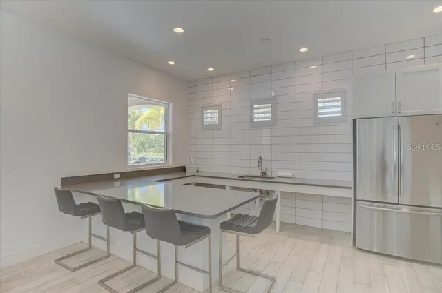 a view of a house with swimming pool and porch with furniture