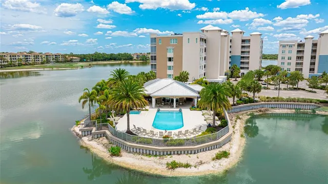 a view of a lake with a table and chairs