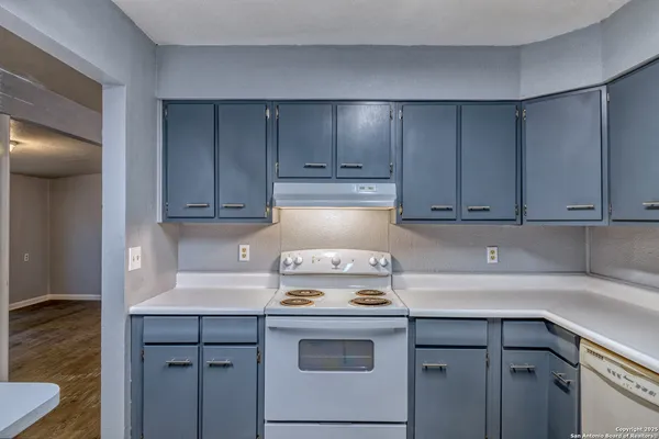 a stove top oven sitting inside of a kitchen