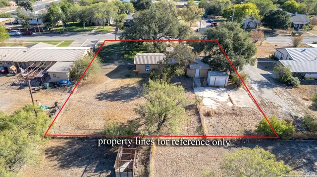 an aerial view of a house with garden space and lake view