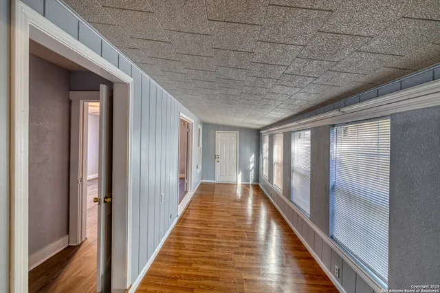a view of gallery with wooden floor