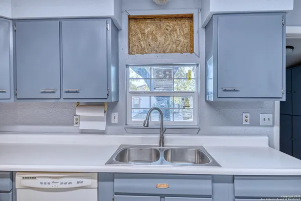 a kitchen with a sink and cabinets